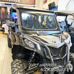 CANAM MAVERICK SPORT/TRAIL FRONT WINDSHIELD 2018+ 'Dirt Warrior Accessories' branding in a showroom setting.