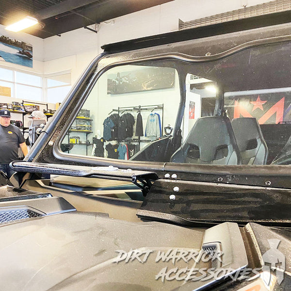 Close-up of CANAM MAVERICK SPORT/TRAIL FRONT WINDSHIELD 2018+ with 'Dirt Warrior Accessories' branding in a store setting.