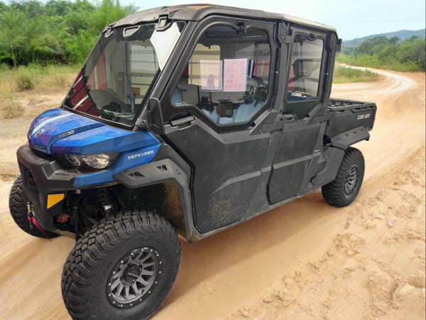 CANAM DEFENDER 4-SEAT VAULT CAB ENCLOSURE ON A DIRT ROAD