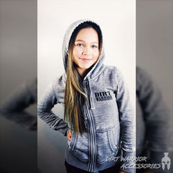 A female model wearing a gray J America ladies' zip-up hoodie with the hood up, Dirt Warrior Accessories logo on front.